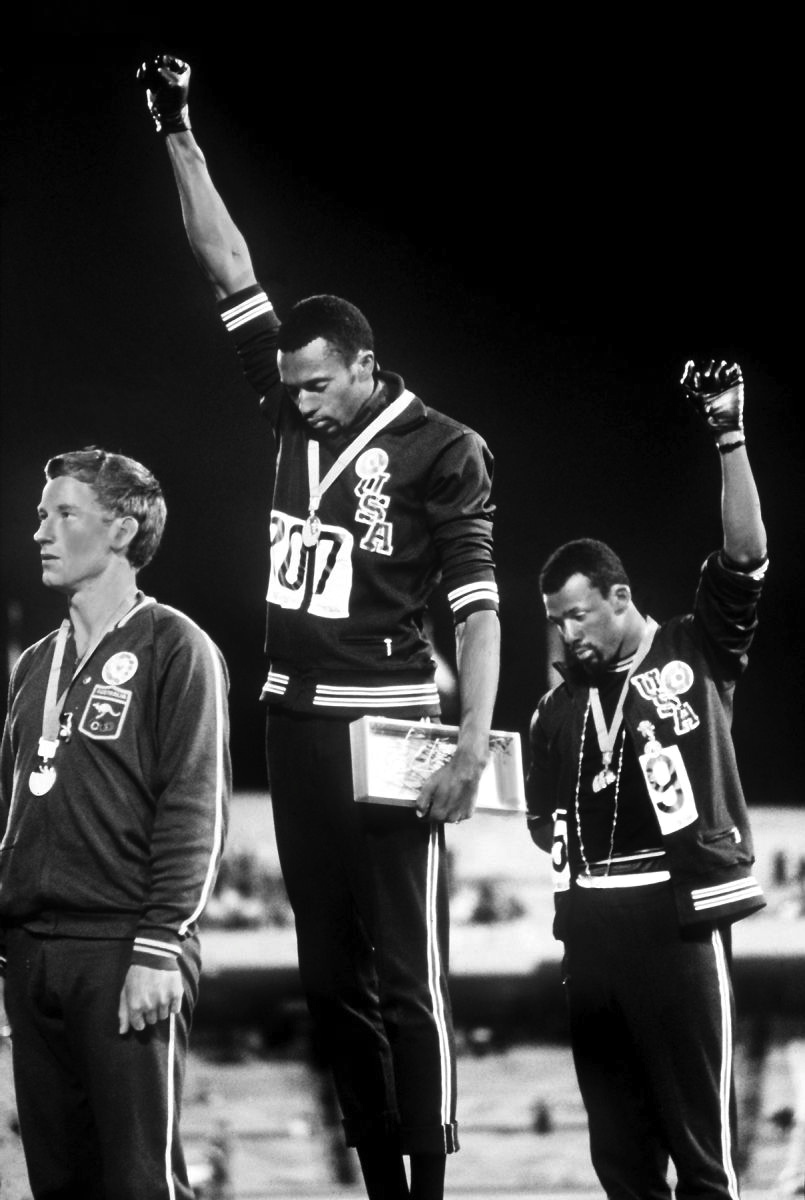 During the 1968 Olympics, in Mexico, Tommie Smith and John Carlos raise their fists during the USA national anthem